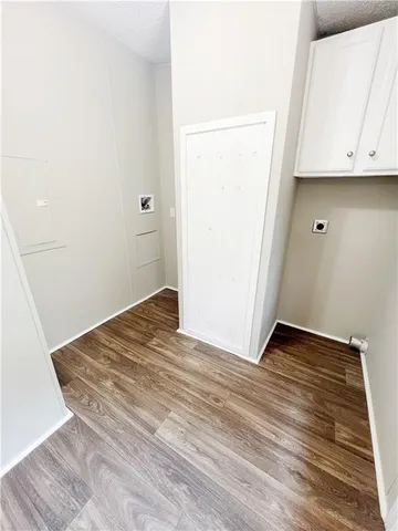 a view of a room with wooden floor