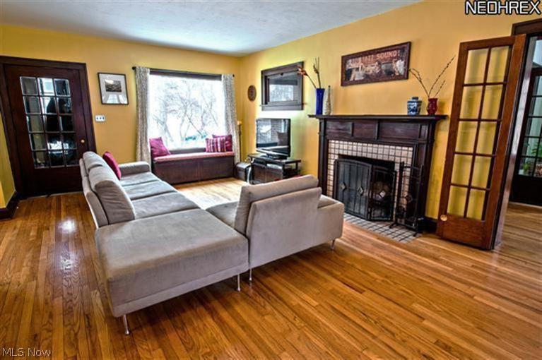 6020 Pearl Road Parma Heights, OH 44130 - Photo 5 of 25 Hardwood carries through to the formal living area. Wood-burning fireplace, another window seat and opens to 1st floor office.