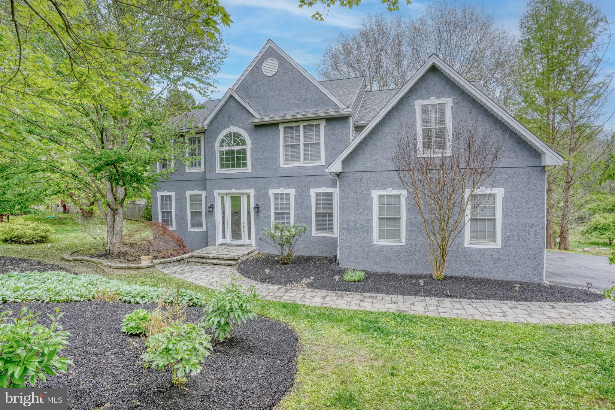 357 Willits Way Garnet Valley, PA 19060 - Photo 2 of 63 a view of a yard in front of a house with large windows