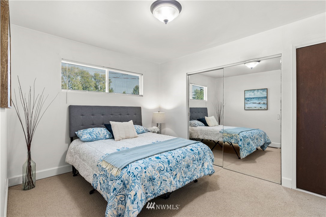 7404 Golden Given Road East Tacoma, WA 98404 - Photo 17 of 23 a bedroom with a bed and lamp