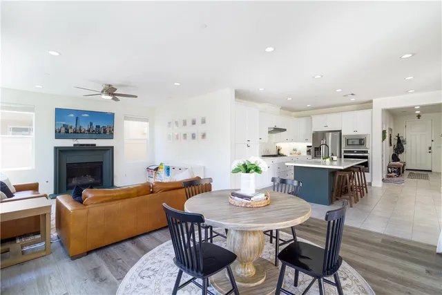 a living room with furniture kitchen view and a fireplace