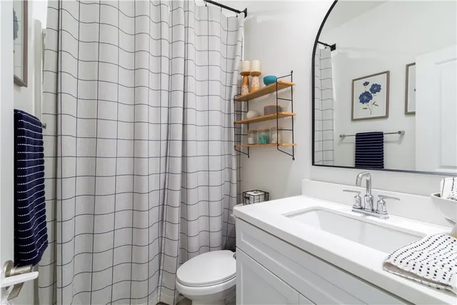 a bedroom with a bed mirror and a window