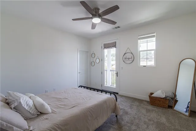 a view of a bedroom with baby crib and cabinet