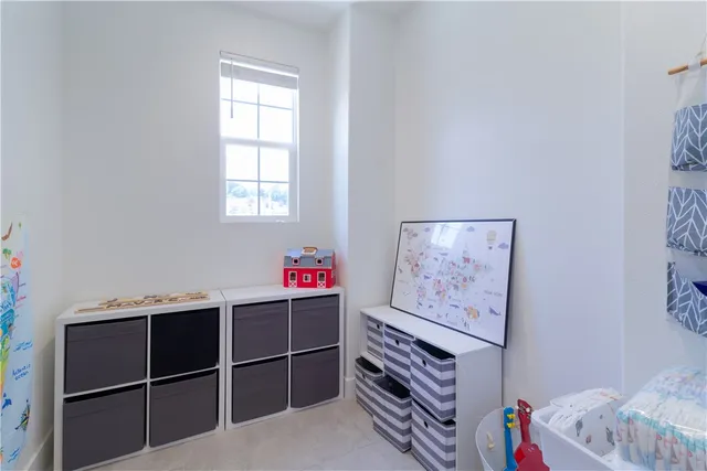 a view of a patio with table and chairs potted plants and large tree