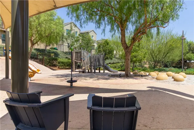 a living room with patio furniture and a floor to ceiling window