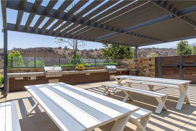 a view of a patio with table and chairs and potted plants