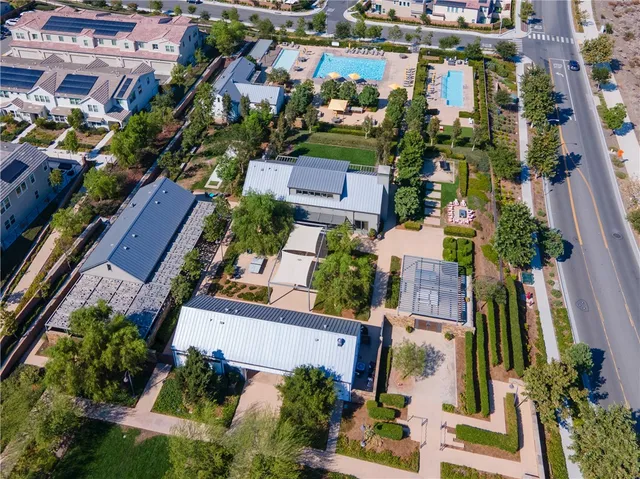 an aerial view of a pool patio kitchen and outdoor seating