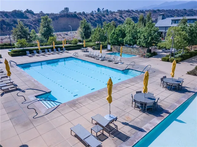 an aerial view of a house with a garden and trees