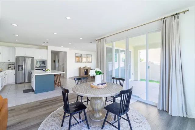 a living room with fireplace furniture and a large window