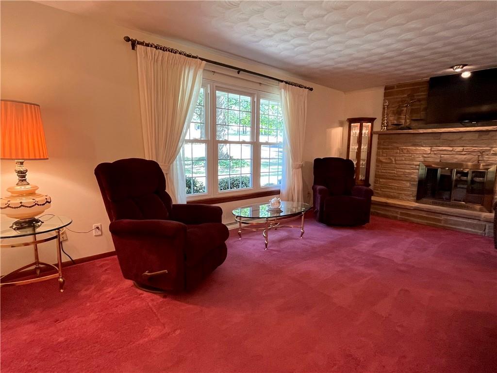 629 Clover Hill Road Somerset, PA 15501 - Photo 16 of 47 a living room with furniture a flat screen tv and a fireplace