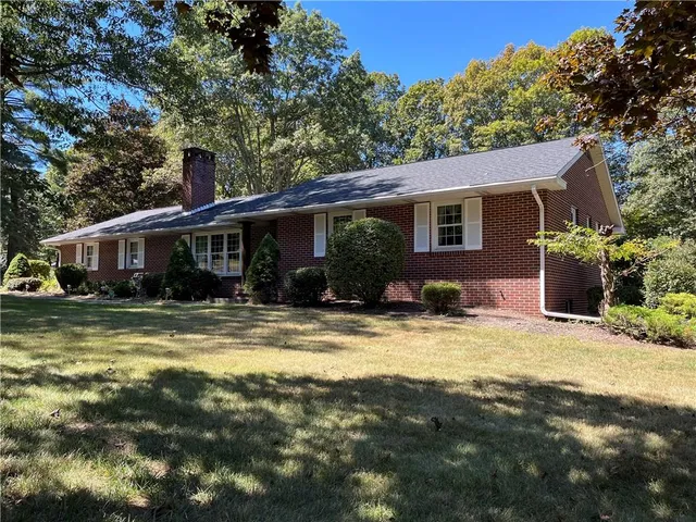 a view of a house with swimming pool and a yard