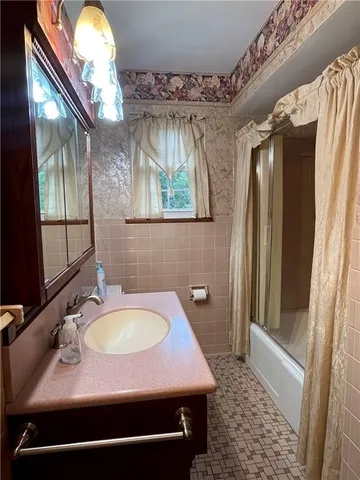 a bathroom with a shower and a tub