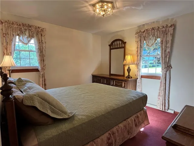 a large bed in a bedroom next to a lamp