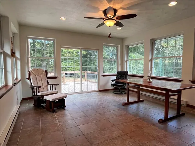 a living room with furniture a floor to ceiling window and a table