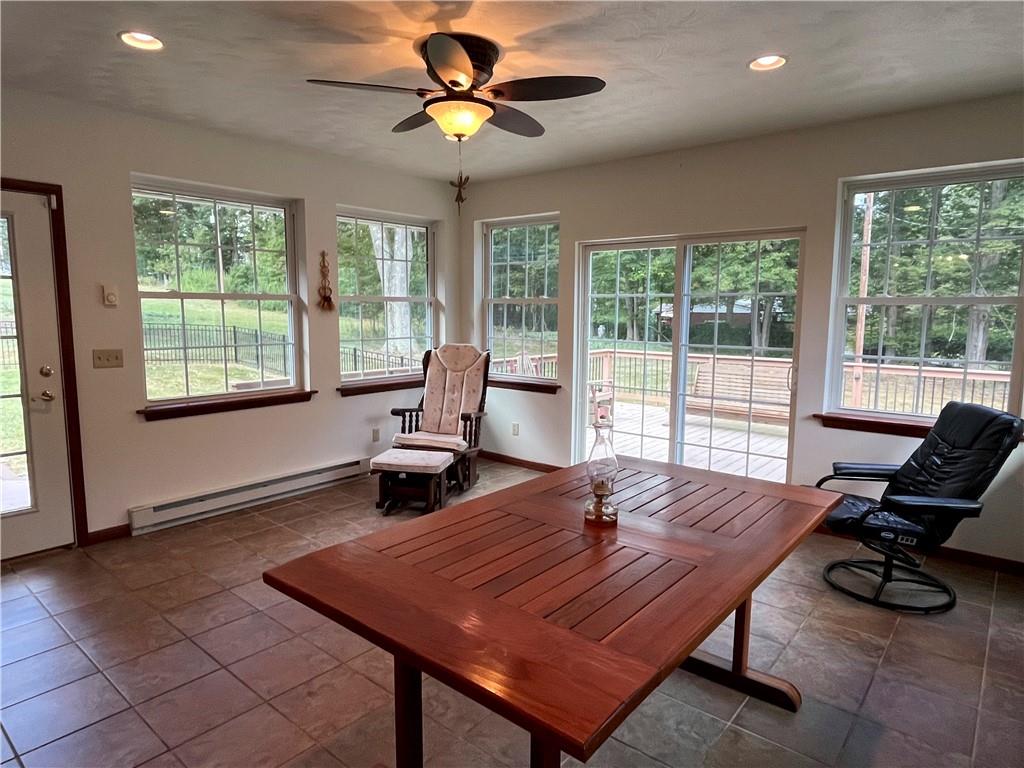 629 Clover Hill Road Somerset, PA 15501 - Photo 37 of 47 a living room with furniture a floor to ceiling window and a table