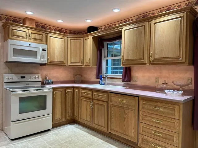 a kitchen with stainless steel appliances granite countertop a sink and a stove