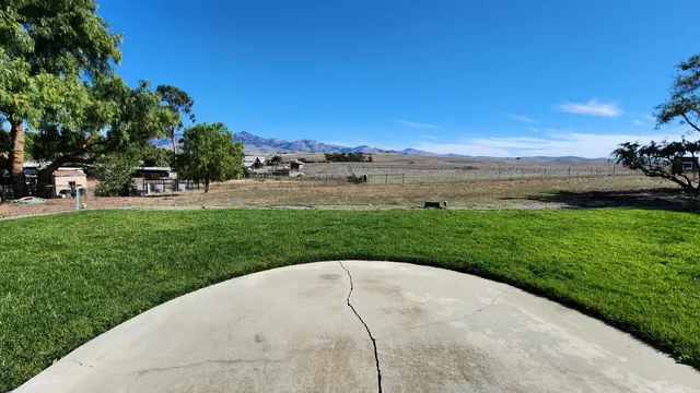 a view of hall way with wooden floor and a fireplace
