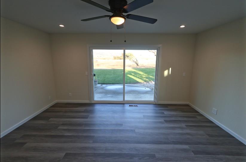 307 Mansfield Road Hollister, CA 95023 - Photo 28 of 62 a view of an empty room with wooden floor and a window