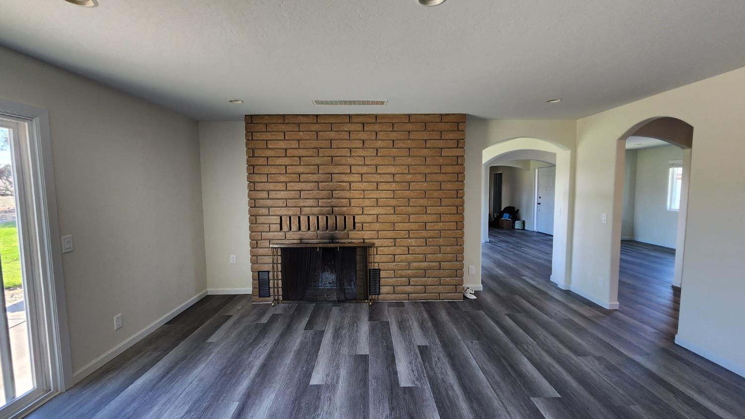 307 Mansfield Road Hollister, CA 95023 - Photo 47 of 62 a view of hall way with wooden floor and a fireplace