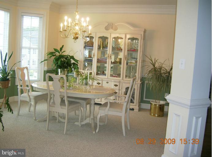 8919 Ricky Trevor Road Perry Hall, MD 21128 - Photo 12 of 27 a view of a dining room with furniture and chandelier