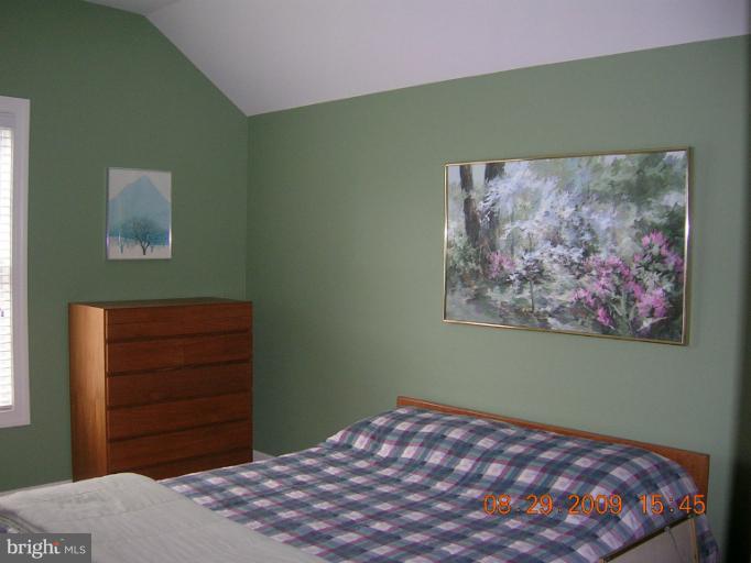 8919 Ricky Trevor Road Perry Hall, MD 21128 - Photo 15 of 27 a bedroom with a bed and a painting on the wall