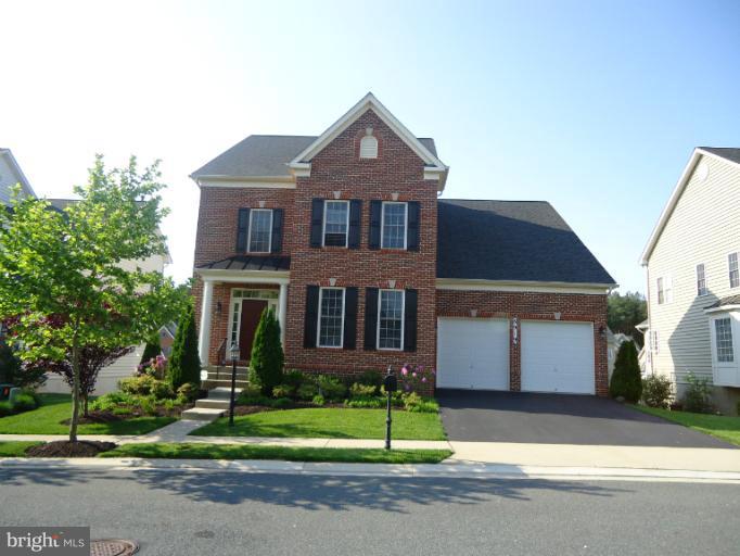 8919 Ricky Trevor Road Perry Hall, MD 21128 - Photo 18 of 27 a front view of a house with a yard and garage
