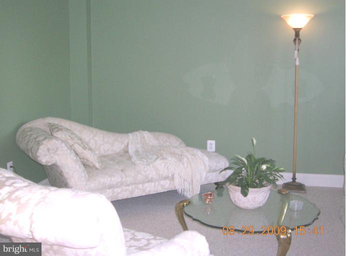 8919 Ricky Trevor Road Perry Hall, MD 21128 - Photo 3 of 27 a bed room with a bed mirror and a lamp