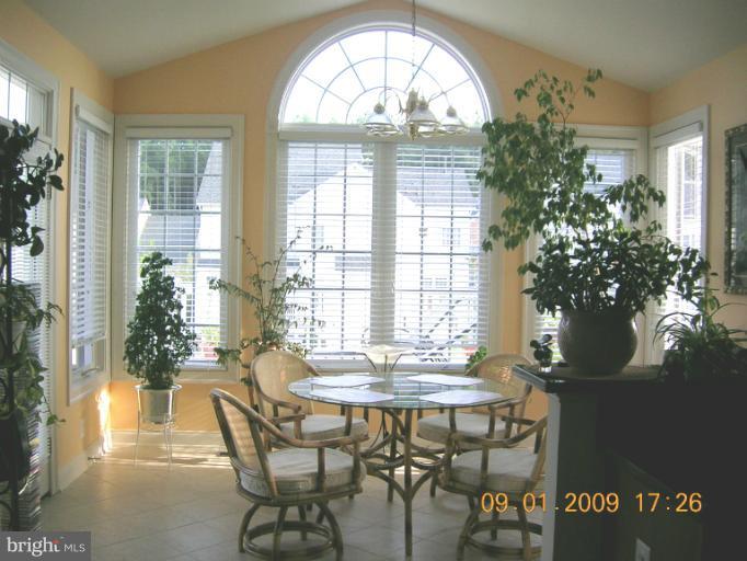8919 Ricky Trevor Road Perry Hall, MD 21128 - Photo 23 of 27 a view of a dining room with furniture and a potted plant