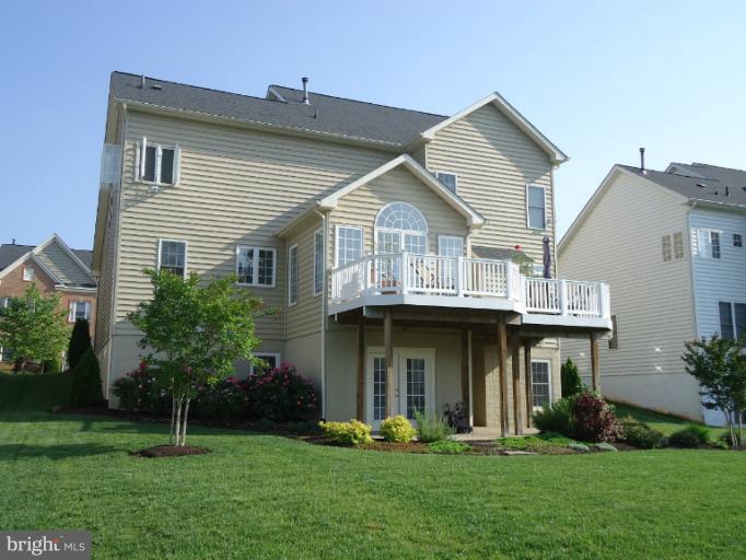 8919 Ricky Trevor Road Perry Hall, MD 21128 - Photo 5 of 27 a front view of a house with a garden and plants