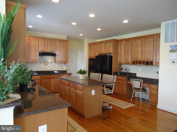 8919 Ricky Trevor Road Perry Hall, MD 21128 - Photo 6 of 27 a kitchen with kitchen island granite countertop counter top space a sink appliances and cabinets