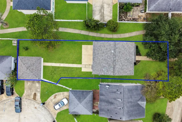 an aerial view of a house with a garden and yard