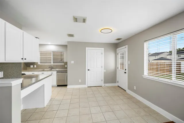 a kitchen with a stove a sink and a refrigerator