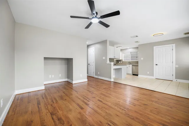 a view of a kitchen with a ceiling fan hardwood floor and a ceiling fan