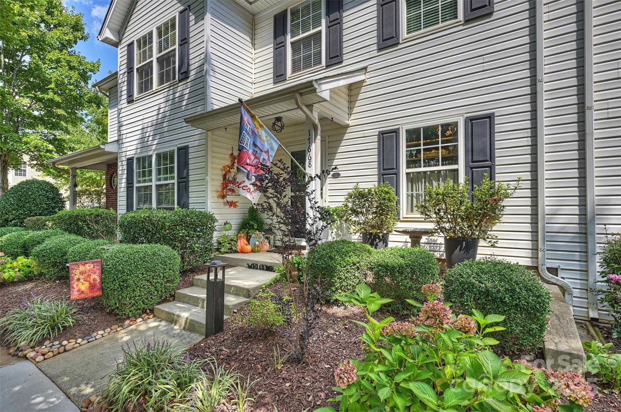 a view of a house with a yard and plants
