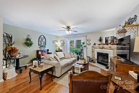a living room with furniture a fireplace and a flat screen tv
