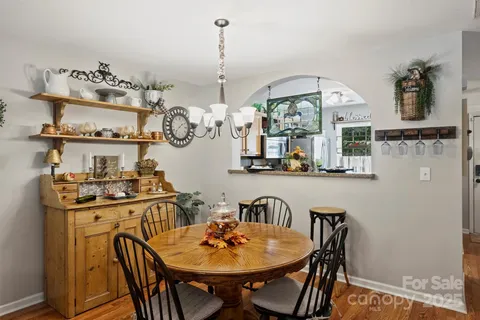 a view of a dining room with furniture and chandelier