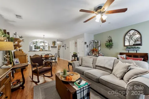 a living room with furniture a rug and a chandelier