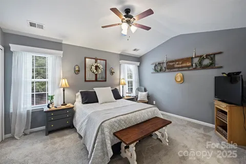 a bedroom with a bed and a tv