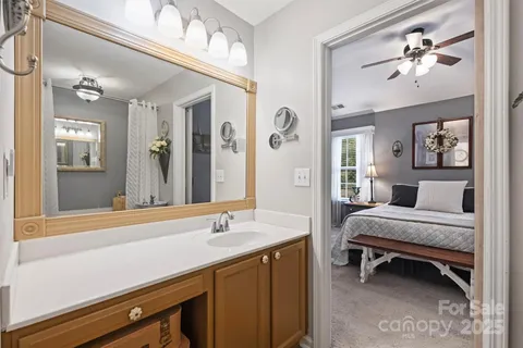 a en suite bathroom with a double vanity sink and a mirror