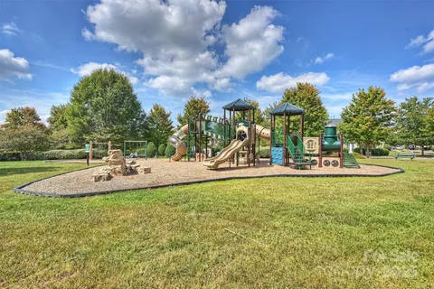 a view of a park with swings and slides