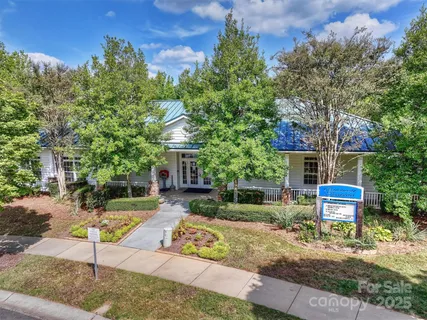 a view of a house with a yard and sitting area
