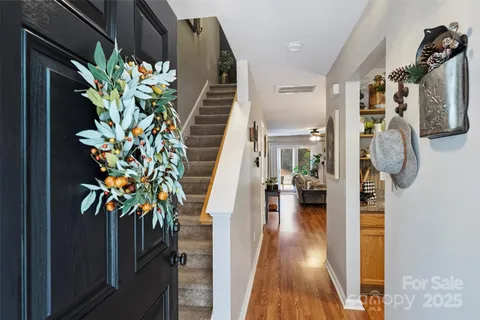 a view of entryway and hall with wooden floor