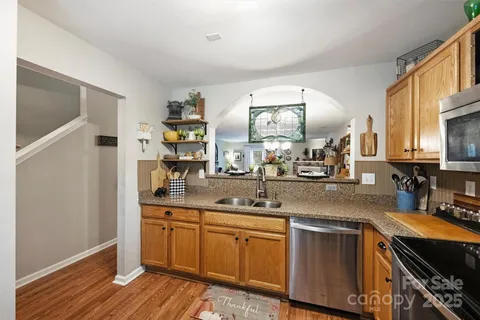 a kitchen with cabinets a sink and appliances
