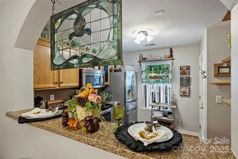 a room with lots of white furniture and wooden floor
