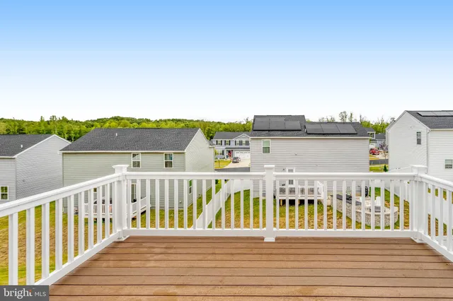 a view of a balcony with wooden floor and fence