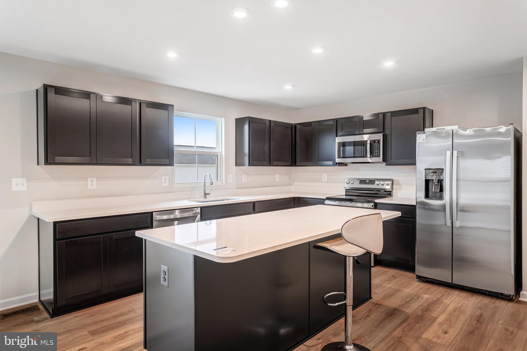1714 Nebula Lane Stafford, VA 22554 - Photo 8 of 29 a kitchen with kitchen island a sink stainless steel appliances and cabinets