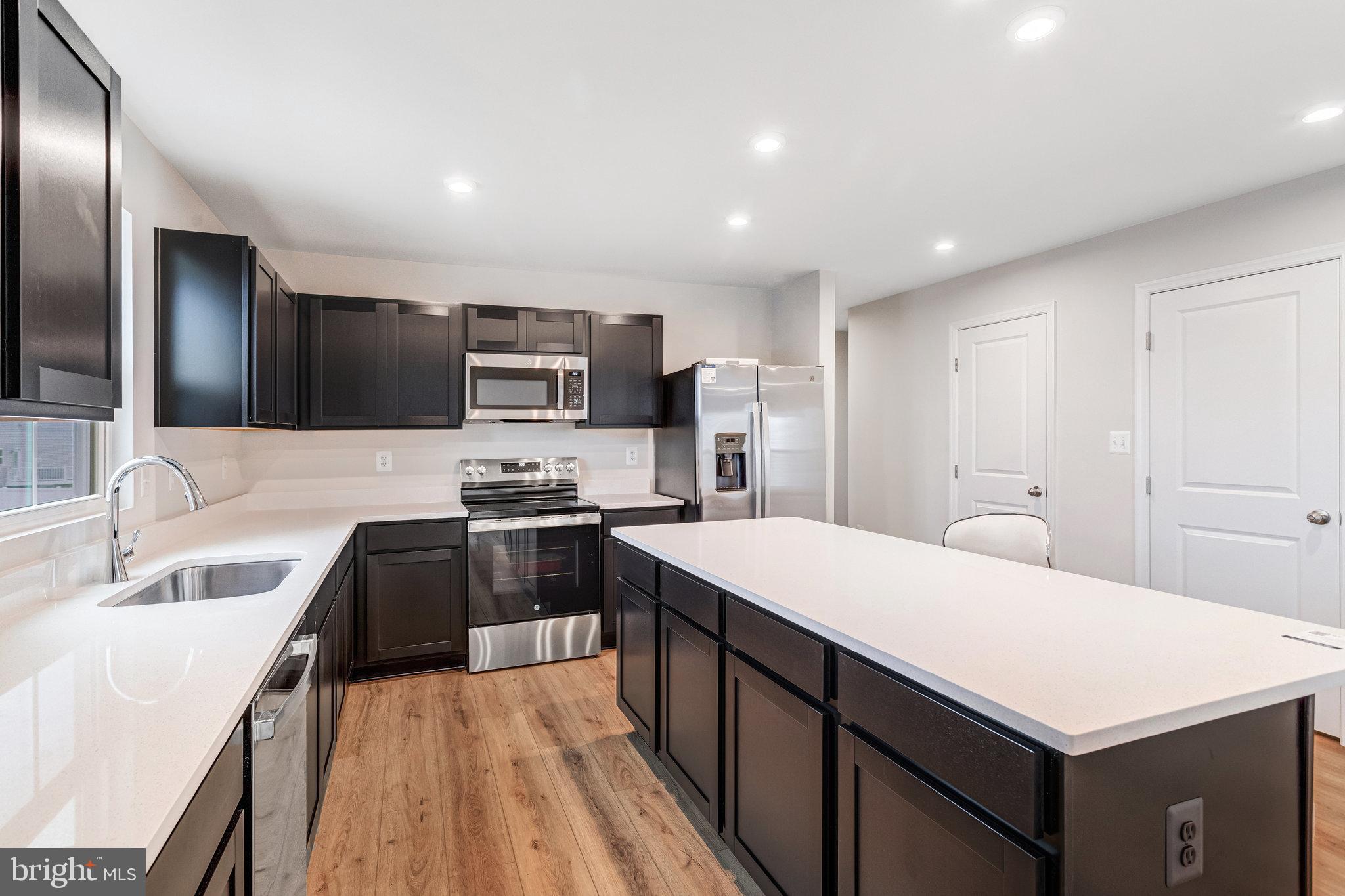 1714 Nebula Lane Stafford, VA 22554 - Photo 9 of 29 a kitchen with stainless steel appliances a sink stove refrigerator and cabinets