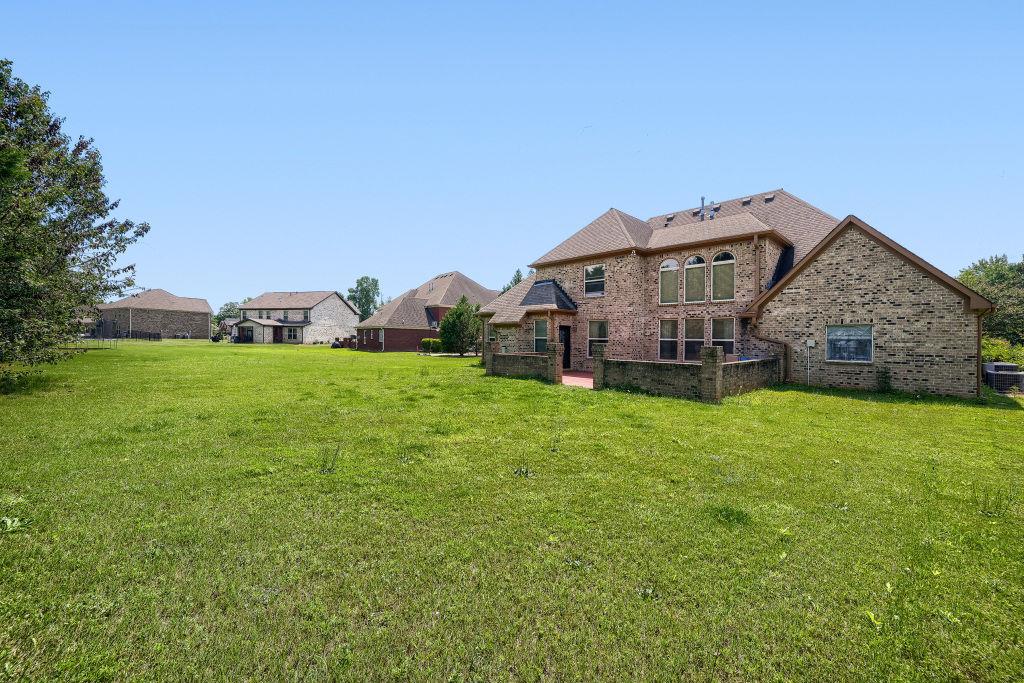 345 Masters Club Boulevard Hampton, GA 30228 - Photo 28 of 30 a view of a house with a big yard and large trees
