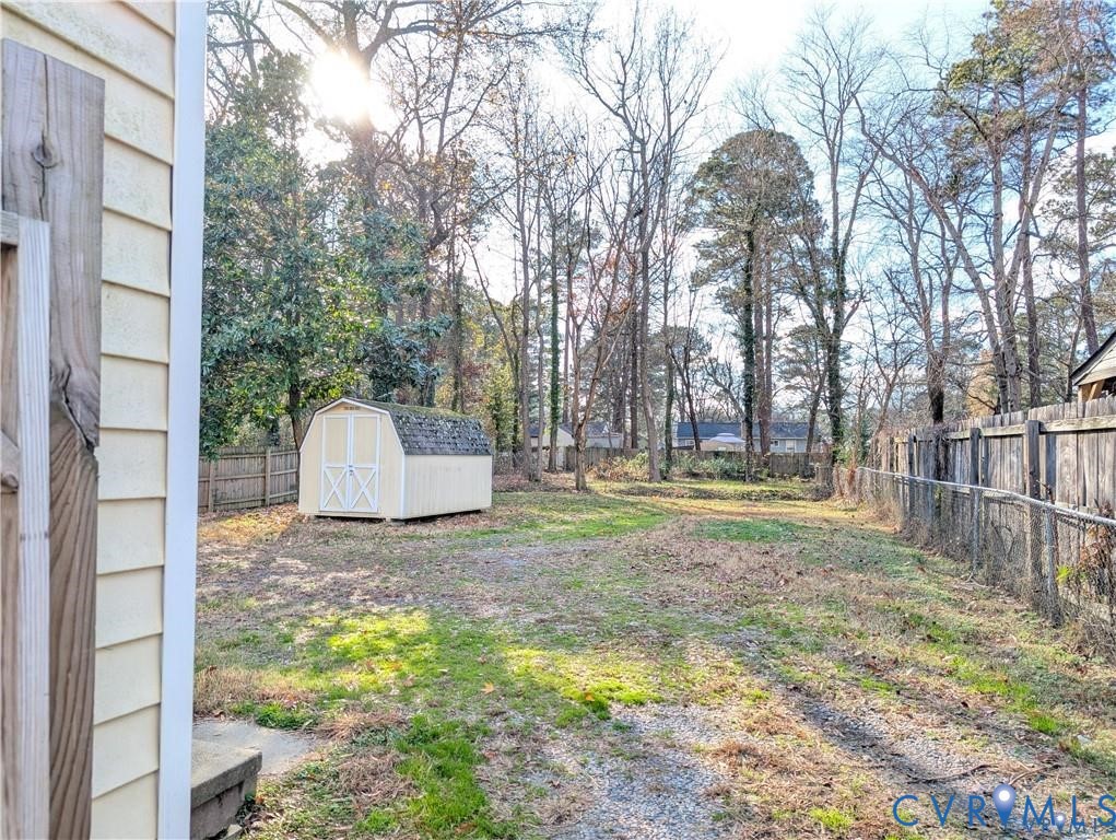 514 German School Road Richmond, VA 23225 - Photo 2 of 11 Fenced backyard featuring a shed