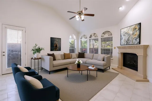 a living room with furniture a chandelier and a fireplace